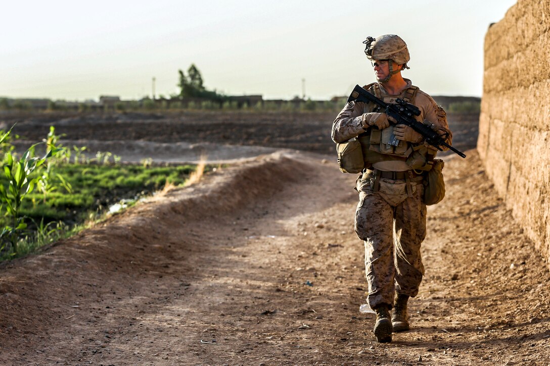 U.S. Marine Corps Lt. Col. Bradley Weston observes surrounding compounds during a security patrol in Nad Ali district in Helmand province, Afghanistan, Oct. 7, 2014. Weston is commander of 1st Battalion, 2nd Marine Regiment. The Marines patrolled to disrupt enemy operations against the Bastion-Leatherneck Complex.