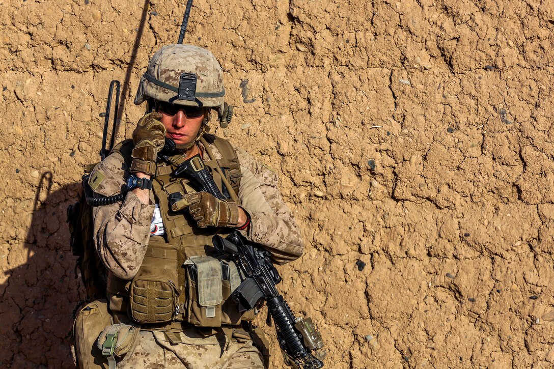 U.S. Marine Corps 1st Lt. Patrick Ford communicates with his Marines in nearby vehicles during a security patrol in Nad Ali district in Helmand province, Afghanistan, Oct. 7, 2014. Ford is a platoon commander assigned to Bravo Company, 1st Battalion, 2nd Marine Regiment.