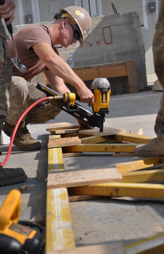 U.S. Navy Petty Officer 3rd Class Zach Mosher completes work on a truss