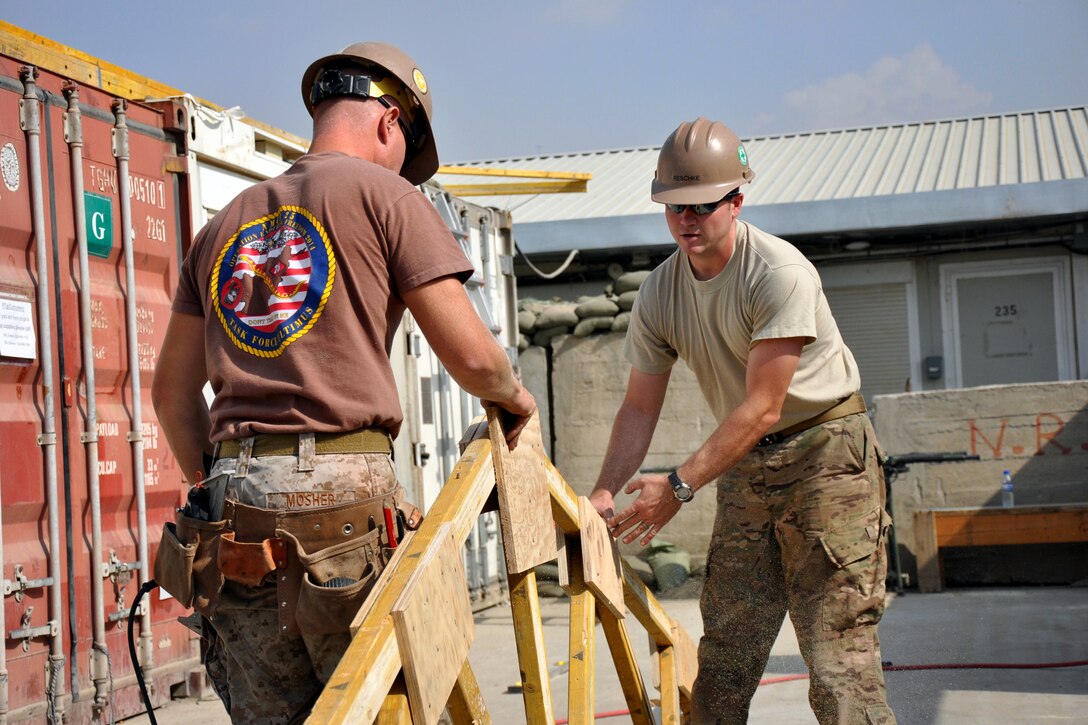 U.S. Navy Petty Officer 3rd Class Zach Mosher, left, and U.S. Army