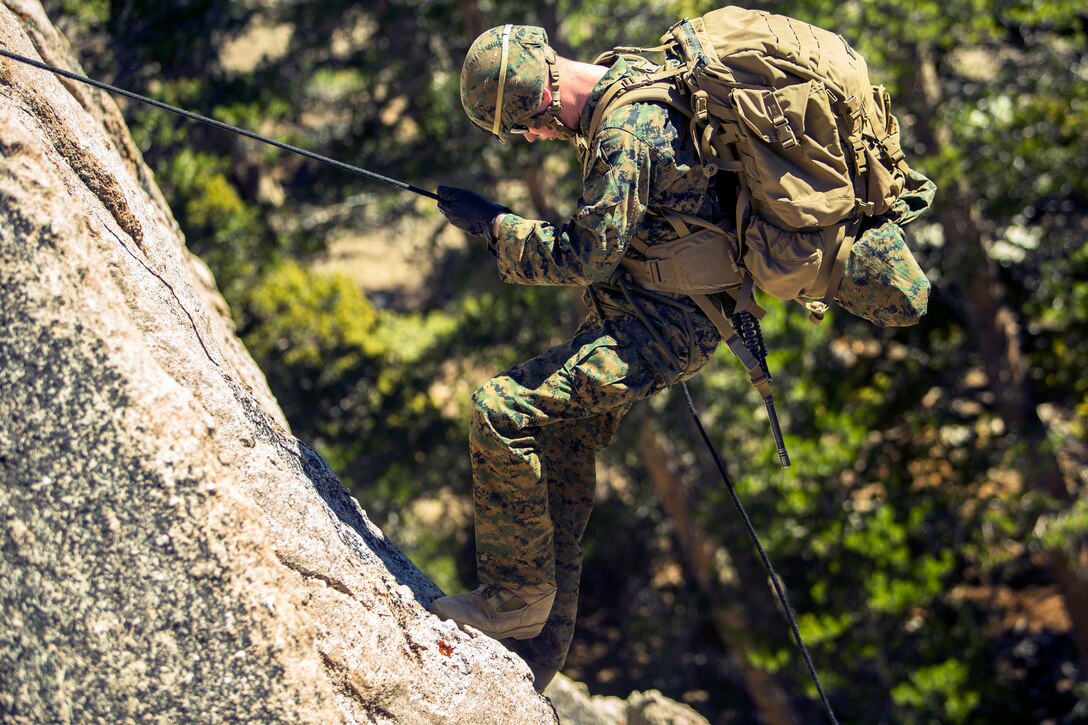 A Marine rappels from Sardine Rock on the Mountain Warfare Training ...