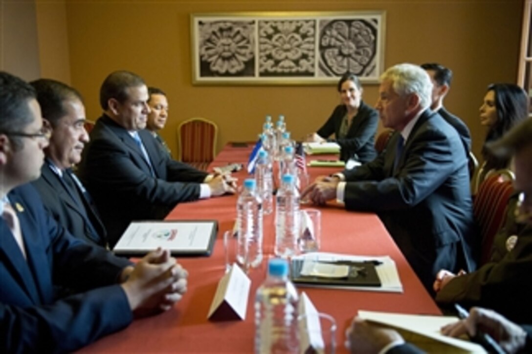 U.S. Defense Secretary Chuck Hagel, right, meets with Honduran Defense Minister Samuel Reyes, left, to discuss matters of mutual importance during the 11th Conference of the Defense Ministers of the Americas in Arequipa, Peru, Oct. 13, 2014.