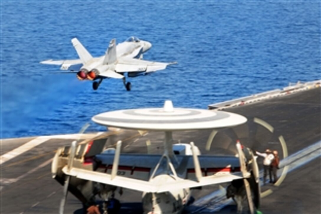 An F/A-18C Hornet attached to Strike Fighter Squadron 15 launches from the flight deck of the aircraft carrier USS George H.W. Bush in the Persian Gulf, Oct. 10, 2014. The George H.W. Bush is supporting maritime security operations, strike operations in Iraq and Syria as directed, and theater security cooperation efforts in the U.S. 5th Fleet area of responsibility. 