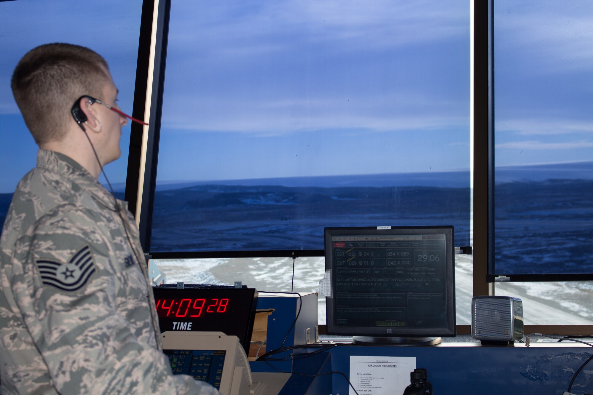 Tech. Sgt. Joseph Sievert, air traffic controller for the 821st Support Squadron, watches for inbound aircraft while working the local control position at Thule AB Sept. 30. The aircraft were carrying cargo to resupply Canadian Forces Station Alert and Eureka Research Station to get them through the harsh winter as a part of Operation Boxtop. (U.S. Air Force photo/Tech. Sgt. Jason Brumbaugh)