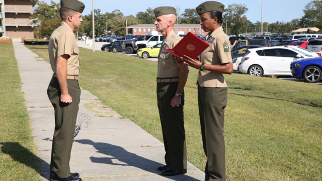 Col. Matthew G. St. Clair, commanding officer, Ground Combat Element Integrated Task Force, presents 1st Lt. Benjamin Sheldon, platoon commander, Company A, GCEITF, with a Navy and Marine Corps Commendation Medal with combat "V" distinguishing device at the task force headquarters, Oct. 10, 2014. Sheldon was awarded for actions during a deployment to Afghanistan with 1st Battalion, 9th Marine Regiment, from September 2013 to May 2014. From October 2014 to July 2015, the GCEITF will conduct individual and collective level skills training in designated ground combat arms occupational specialties in order to facilitate the standards based assessment of the physical performance of Marines in a simulated operating environment performing specific ground combat arms tasks. (U.S. Marine Corps photo by Cpl. Paul S. Martinez/Released)