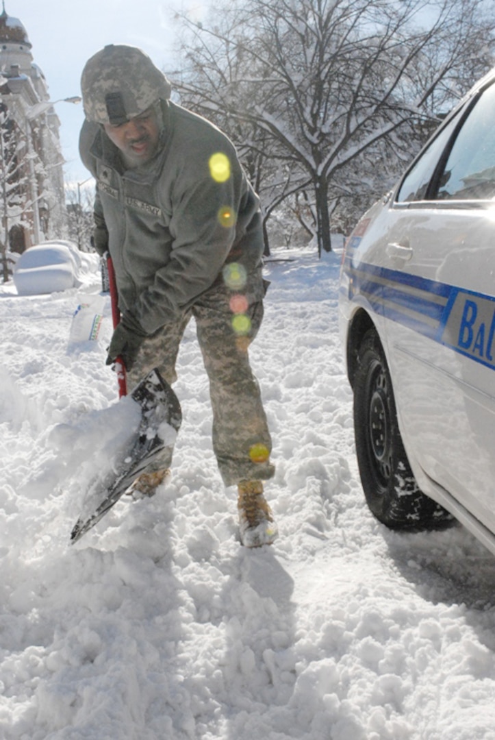 Cpt. Christian Callender of the 29th Mobile Public Affairs Detachment of the Maryland National Guard assists a motorist, who was stranded in his vehicle on Route 95 South, just outside of Baltimore, Md.