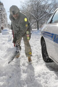 Cpt. Christian Callender of the 29th Mobile Public Affairs Detachment of the Maryland National Guard assists a motorist, who was stranded in his vehicle on Route 95 South, just outside of Baltimore, Md.