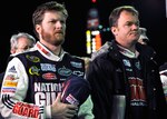 Dale Earnhardt Jr., (left) driver for the No. 88 National Guard-sponsored NASCAR race team and his crew chief Lance McGrew listen to the National Anthem prior to the Feb. 6 start of the Budweiser Shootout at Daytona International Speedway, Fla.