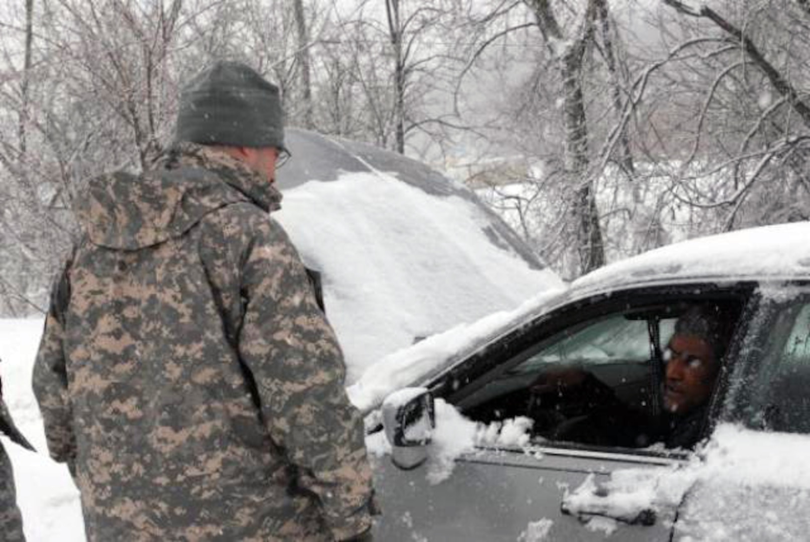 Cpt. Christian Callender of the 29th Mobile Public Affairs Detachment of the Maryland National Guard assists a motorist, who was stranded in his vehicle on Route 95 South, just outside of Baltimore, Md.
