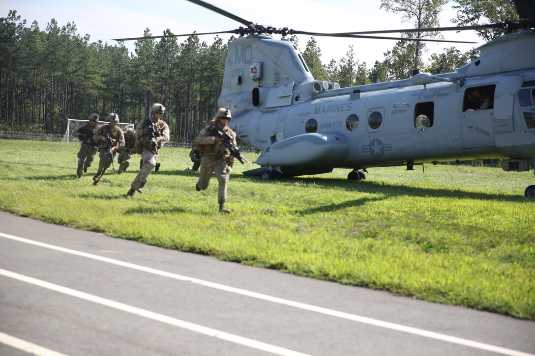 Marines with 3rd Battalion, 2nd Marine Regiment, 2nd Marine Division disembark from a CH-46 Sea Knight helicopter to assault the Military Operations on Urban Terrain town at Fort A.P. Hill, Va., Sept. 11, 2014. The battalion utilized the training town in preparation for the unit’s upcoming Integrated Training Exercise later this year.