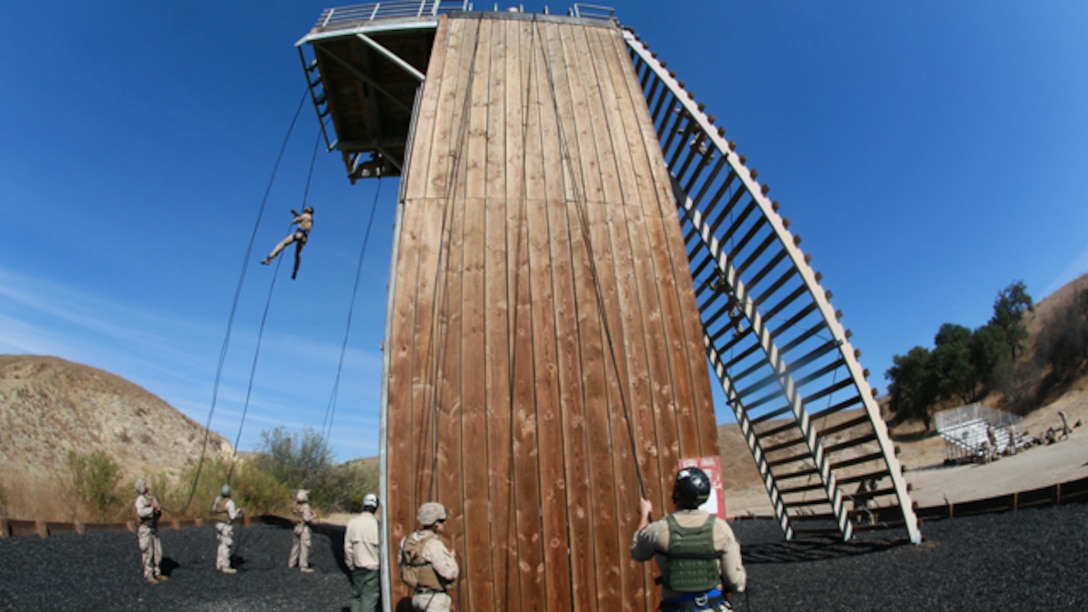 U.S. Marines with Battalion Landing Team, 3rd Battalion, 1st Marine Regiment, practice rappelling techniques during a helicopter rope-suspension techniques masters course aboard Camp Pendleton, Calif., Oct. 14, 2014. BLT 3/1 is deploying this spring as the 15th Marine Expeditionary Unit’s ground combat element. (U.S. Marine Corps photo by Sgt. Jamean Berry/Released)