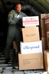 Master Sgt. Eric Henderson, a boom operator from the 151st Operations Group of the Utah National Guard, unloads school supplies for a Moroccan orphanage Jan. 24, 2010. The 50 school kits, which were assembled and donated by spouses of the Utah National Guard's senior enlisted leaders, were flown on a Utah ANG KC-135. The aircraft will participate in the Aeroexpo Marrakech 2010 scheduled for January 27-30 in Morocco.