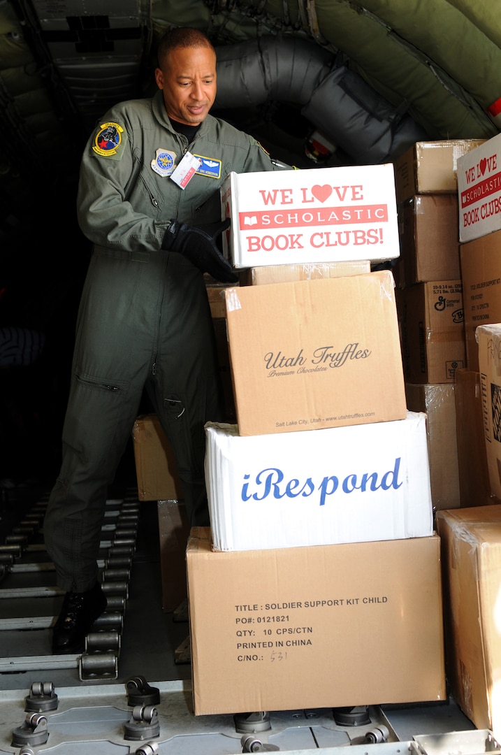 Master Sgt. Eric Henderson, a boom operator from the 151st Operations Group of the Utah National Guard, unloads school supplies for a Moroccan orphanage Jan. 24, 2010. The 50 school kits, which were assembled and donated by spouses of the Utah National Guard's senior enlisted leaders, were flown on a Utah ANG KC-135. The aircraft will participate in the Aeroexpo Marrakech 2010 scheduled for January 27-30 in Morocco.
