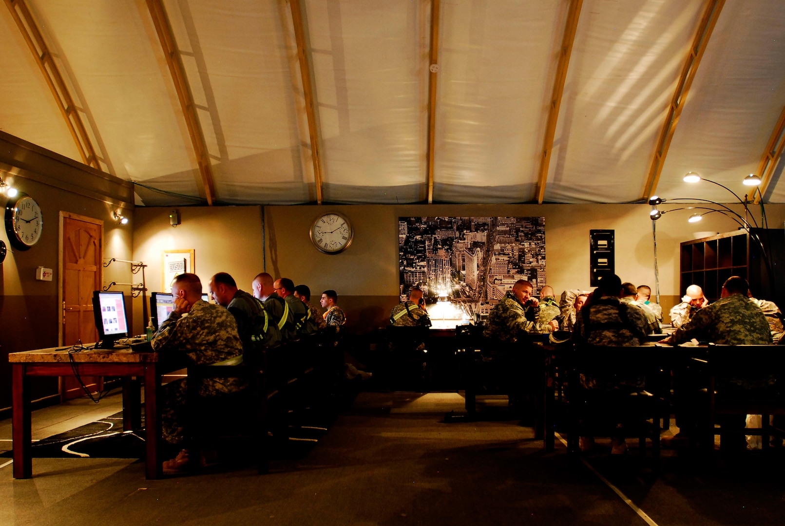 Soldiers enjoy down time while catching up with family and friends at the USO within Camp Virginia, Kuwait. The complex at the camp includes computers, telephones, video games, television sets, a movie theater and a "United Through Reading" room.