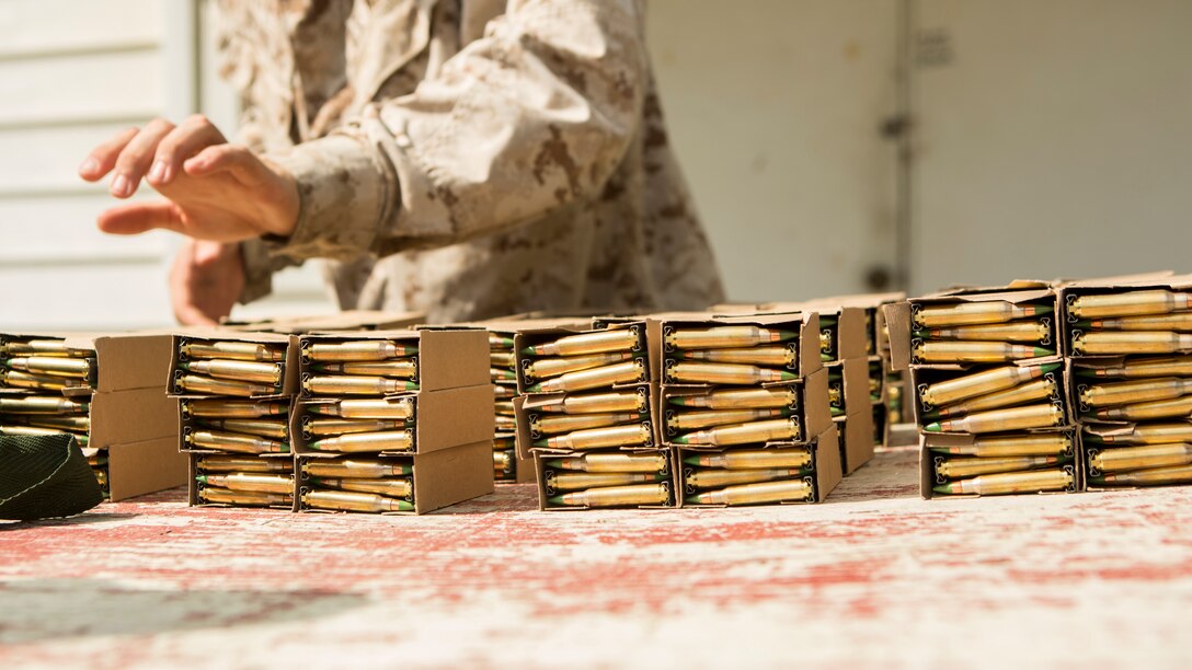Marines with Charlie Company, 2nd Assault Amphibian Battalion, 2nd Marine Division, unload, unbox and organize live ammo that will be utilized during a course of fire at Fort A.P. Hill, Va., Sept. 2, 2014. The Marines spent the entire day shooting an unknown distance range with the M4 Carbine and the M249 squad automatic weapon to better themselves at estimating distances and eliminating a target. (U.S. Marine Corps photo by Lance Cpl. Justin Updegraff / Released)