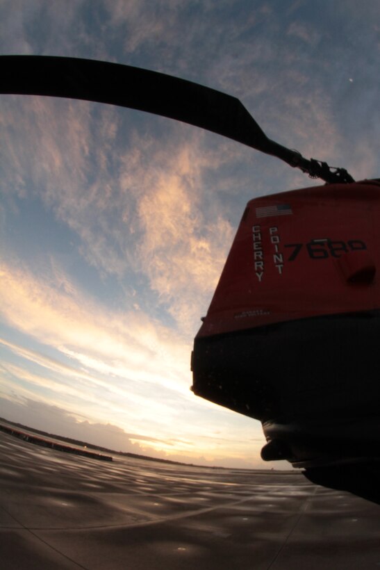 The tail end of an HH-46E Sea Knight helicopter is silhouetted by the rising sun at Marine Corps Air Station Cherry Point, N.C., Oct. 14, 2014.
The Marines of VMR-1 specialize in land and sea search and rescue and transport of military personnel. VMR-1 is the only squadron in the Marine Corps whose primary mission is SAR and is the last remaining Marine Corps squadron to fly the Sea Knight.
