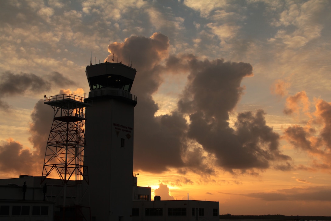 The air traffic control tower is silhouetted by the rising sun over Marine Corps Air Station Cherry Point, N.C., Oct. 14, 2014. 
Cherry Point is home to 2nd Marine Aircraft Wing and several of its squadrons. Cherry Point's runways operate 24/7, 365 days each year, and the air station hosts squadrons that specialize in air-to-ground attack support; electronic warfare; aerial transport and refueling; and sea and land search and rescue.
