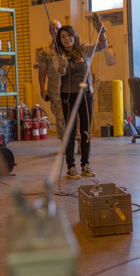 Sarahi Chavez, wife of Sgt. Luis Chavez, plays a training game during the Headquarters and Headquarters Squadron (H&HS) Jane Wayne Day event aboard Marine Corps Air Station Miramar, Calif., Oct. 10. Spouses visited the Carlos Hathcock Range Complex and Explosive Ordnance Disposal Compound to see what some of the Marines with their unit do.