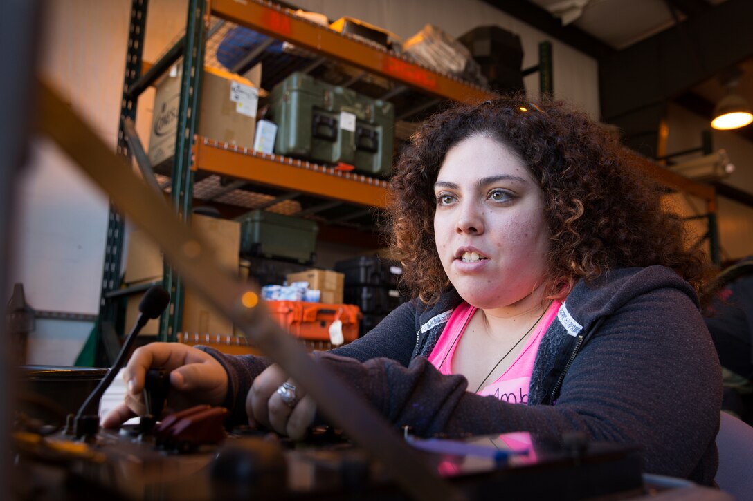 Amber Carrizales, wife of Cpl. Ismael Carrizales, controls an explosive ordnance disposal robot during the Headquarters and Headquarters Squadron (H&HS) Jane Wayne Day event aboard Marine Corps Air Station Miramar, Calif., Oct. 10. Spouses were able to fire an M16 rifle, control an EOD robot, wear full explosive protective gear and play a training-based game.