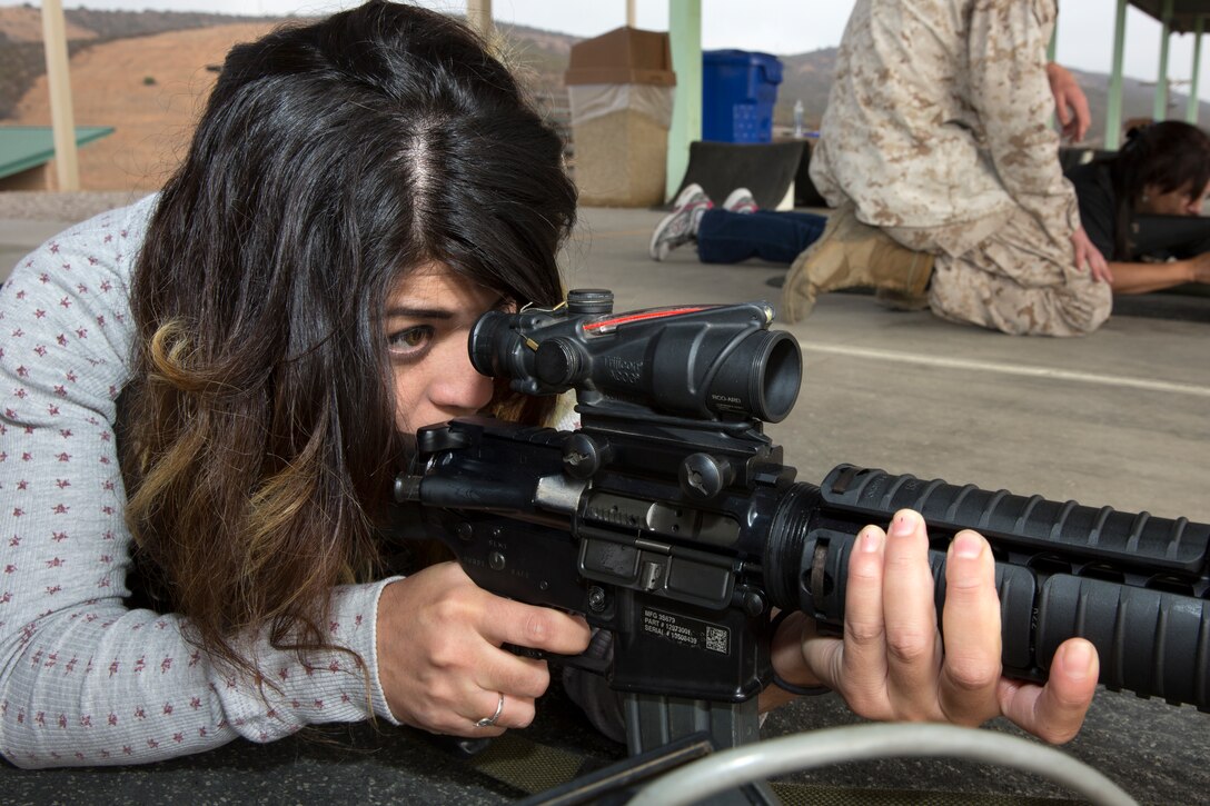 Sarahi Chavez, wife of Sgt. Luis Chavez, fires an M16 rifle during the Headquarters and Headquarters Squadron (H&HS) Jane Wayne Day event aboard Marine Corps Air Station Miramar, Calif., Oct. 10. The event allowed spouses a chance to experience some of what their Marines do for work and for training.