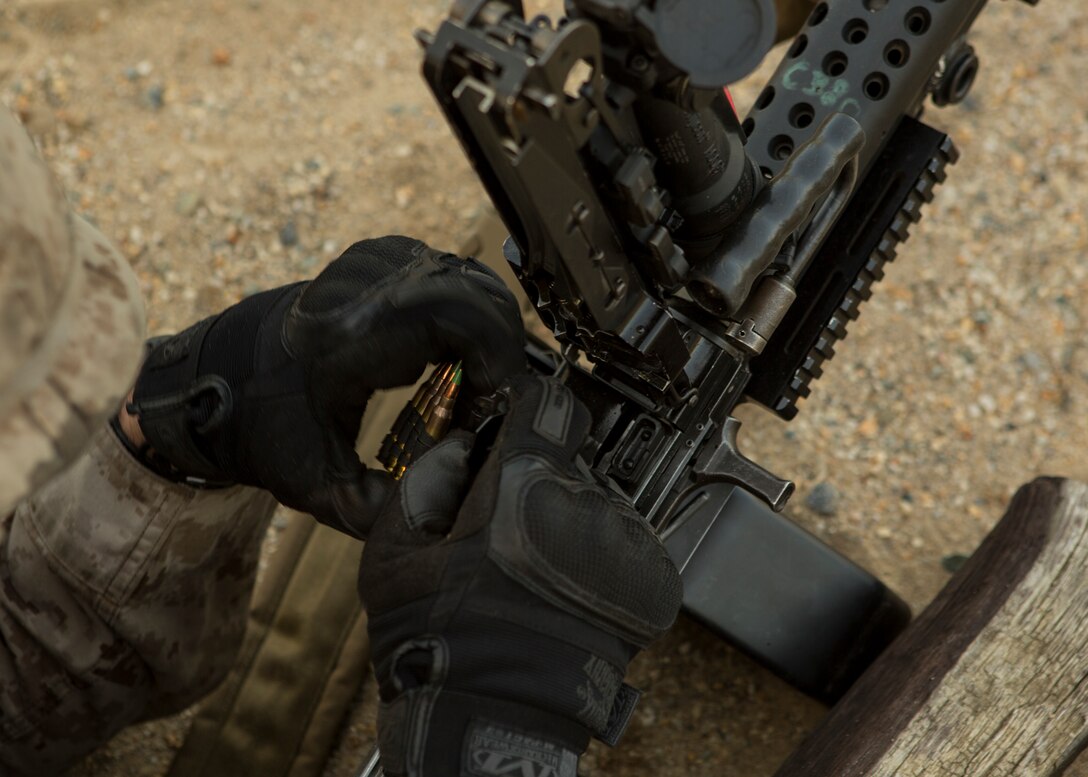 Lance Cpl. Walter Lindner, an assault amphibious vehicle crewman, fires his M-249 squad automatic weapon at pop up targets down range at Fort A.P. Hill, Va., Sept. 2, 2014. The Marines spent the entire day shooting an unknown distance range with the M4 Carbine and the M249 squad automatic weapon to better themselves at estimating distances and eliminating a target.   