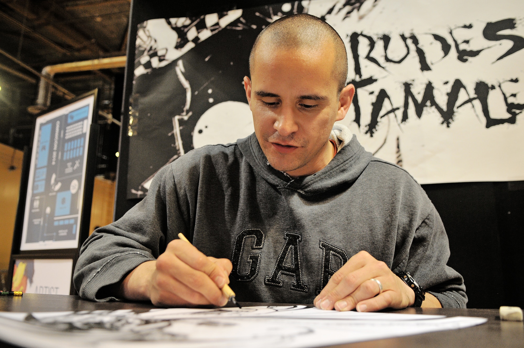 U.S. Air Force Capt. Rudy Talamantez, 35th Logistics Readiness Squadron operations officer, draws a piece of original comic book artwork during Misawa Omnicon at Misawa Air Base, Japan, Oct. 11, 2014. Talamantez, alongside other artists, took the opportunity to share original artwork during the gaming convention. (U.S. Air Force photo by Senior Airman Jose L. Hernandez-Domitilo)