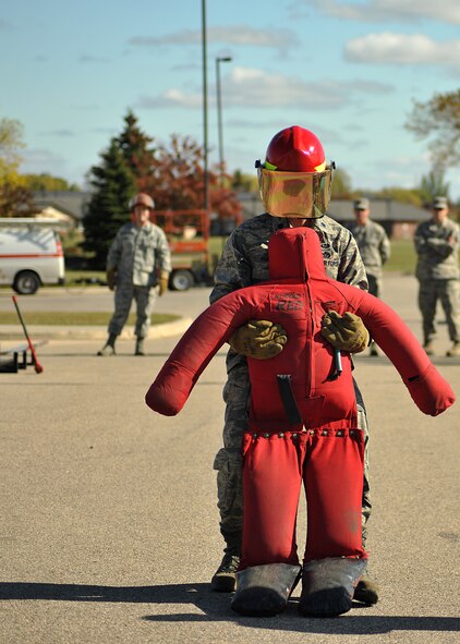 Lt. Col. Edward Phillips, 319th Civil Engineer Squadron commander, drags a dummy through a timed fireman team challenge course on Oct. 9, 2014, on Grand Forks Air Force Base, N.D. Phillips had the third fastest individual time of one minute and 21 seconds. (U.S. Air Force photo/Senior Airman Xavier Navarro) 