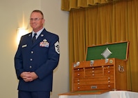 Chief Master Sgt. Brian Randolph stands next to a wooden tool box presented to him during his retirement ceremony Oct. 15 at Club Muroc. The tool box was presented by Brig. Gen. Michael Brewer, 412th Test Wing commander. Randolph has served the Air Force for 30 years, the last two as the 412th TW command chief where he served as the principle advisor to Brewer on matters concerning morale, welfare, discipline, training, fitness and effective utilization of the wing's 12,000 military, civilian, contractor personnel and their families.

Randolph was a maintainer by trade and has deployed to several locations and served as maintenance group superintendent in support of Operation Iraqi Freedom, Enduring Freedom, Joint Task Force-Horn of Africa, and most recently, Afghanistan. 
(U.S. Air Force photo by Jet Fabara)
