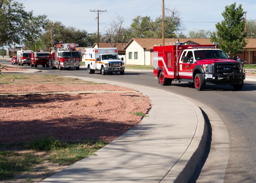 During the National Fire Prevention Week closing ceremony, Holloman Fire Services form a parade through the Soaring Heights housing community area on Holloman Air Force Base, N.M. Oct. 11. Fire Prevention Week ran from Oct. 5 until Oct. 11. The reason for this awareness week started in 1922 as a dedication and remembrance to those who lost their lives and property to the Great Chicago Fire of 1871. Emergency Services provided guided tours of the fire stations, fire response demonstrations, and held a fire fighter challenge as part of their contribution to fire safety awareness and to those that served before them. (U.S. Air Force photo by Staff Sgt. E’Lysia Wray/Released)