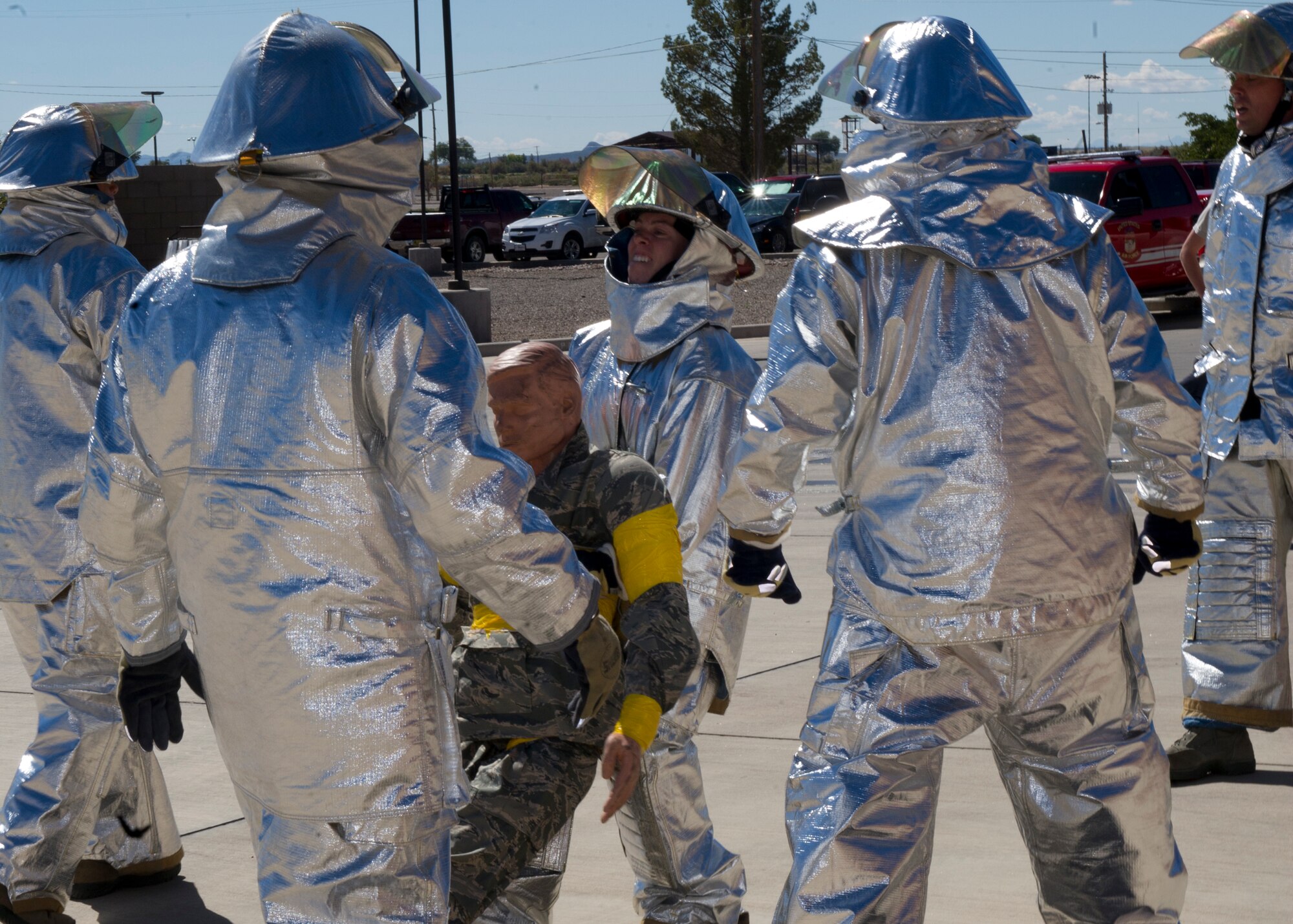 A member from Team Holloman participates in the 100-foot dummy drag event at the 2nd Annual Firefighter Challenge at Holloman Air Force Base, N.M. Oct. 10. The practice dummy weighs approximately 165 pounds. Some of the other events held at the challenge included a stair climb with a hotel pack, a 45-pound hose roll pull, the force sled also known as the Kiser sled, a serpentine run, and a 100-foot hose pull. The purpose of the fire fighter challenge is to let the general public have a chance to try the everyday tasks that firefighters have to encounter. (U.S. Air Force photo by Staff Sgt. E’Lysia Wray/Released)
