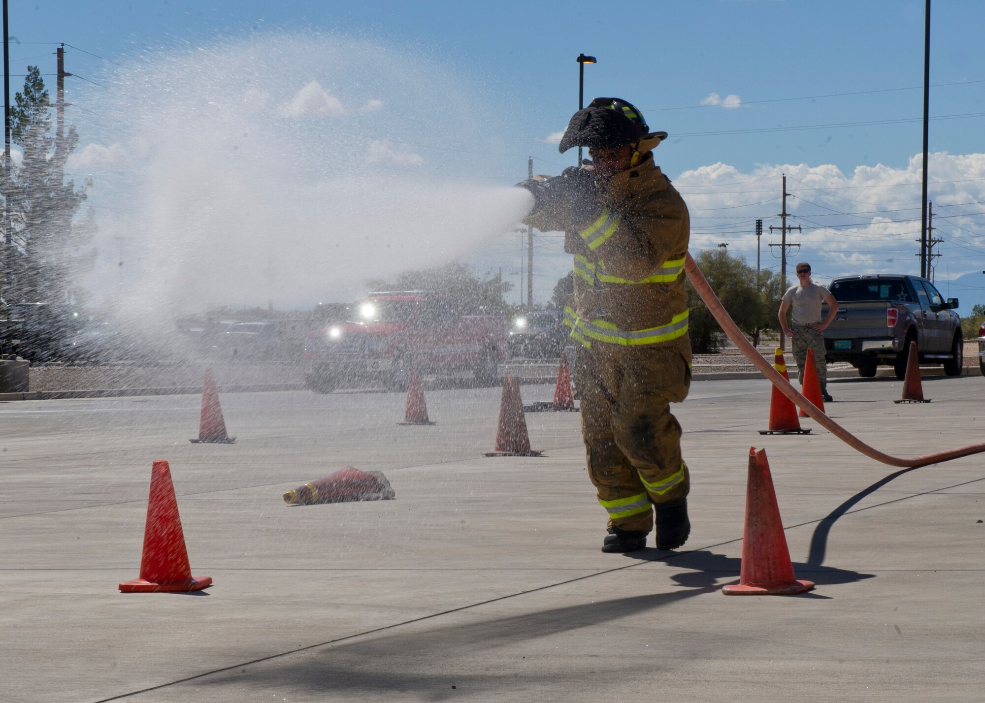 A Holloman Fire Emergency Services firefighter participates in the 100-foot hose pull event at the 2nd Annual Fire Fighter Challenge at Holloman Air Force Base, N.M. Oct. 10. Some of the other events held at the challenge included a stair climb with a hotel pack, a 45-pound hose roll pull, the force sled also known as the Kiser sled, a serpentine run, and a 100-foot dummy drag. The purpose of the fire fighter challenge is to let the general public have a chance to try the everyday tasks that firefighters have to encounter. (U.S. Air Force photo by Staff Sgt. E’Lysia Wray/Released)