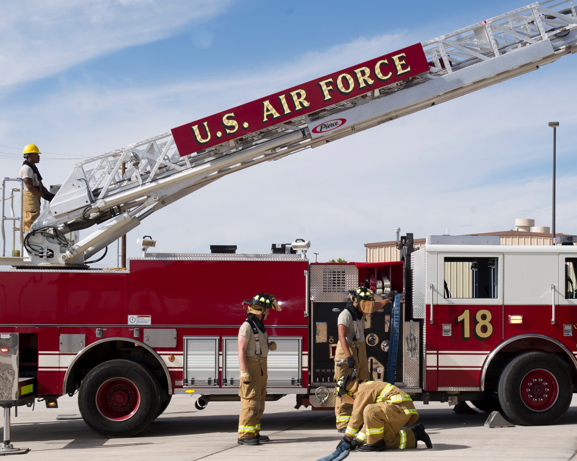 Holloman Fire Emergency Services airmen wrap up a response demonstration during Fire Prevention Week at Holloman Air Force Base, N.M. Oct. 7. A Ladder’s crew consists of a crew chief, who is in charge of the entire crew and can be distinguished by a red helmet, a driver operator, who is the driver and operates the ladder, a lineman, who is in charge of pulling the fire hose out, and a plugman, who is in charge of connecting the fire hose to the truck. (U.S. Air Force photo by Staff Sgt. E’Lysia Wray/Released)