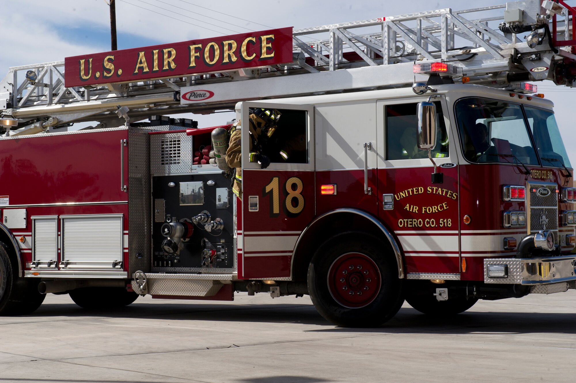 Ladder 18 from Fire Station 2 demonstrates a response to a fire emergency at Holloman Air Force Base, N.M. Oct. 7 for Fire Prevention Week. Throughout the week, Holloman Fire Emergency Services held fire drills and several base appearances to raise awareness about fire prevention. Emergency Services stressed the importance of checking smoke detector batteries on a monthly basis and the importance of always having an escape plan. (U.S. Air Force photo by Staff Sgt. E’Lysia Wray/Released)