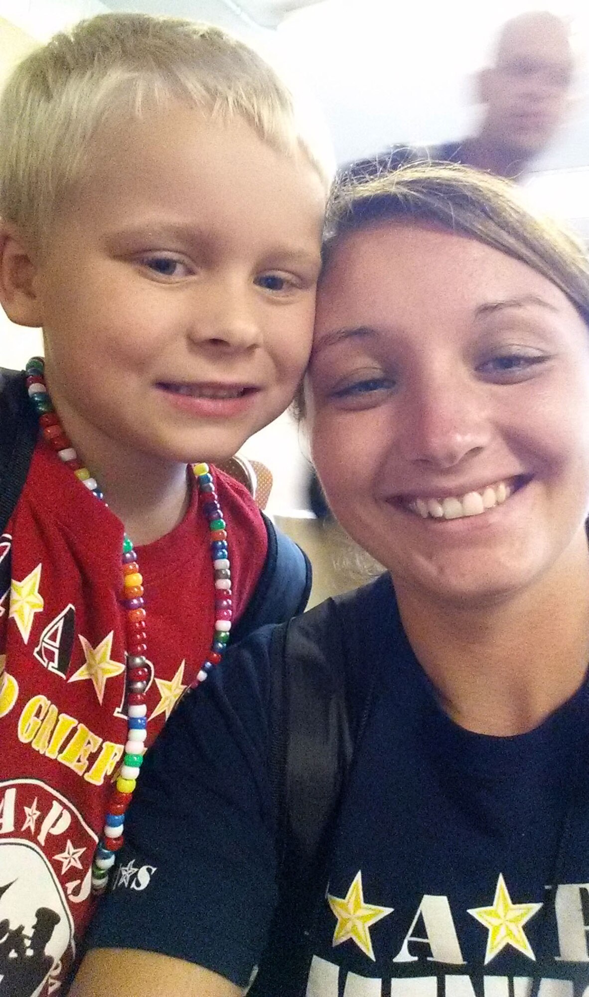 Airman 1st Class Tori Schultz, 6th Air Mobility Wing photojournalist, and her five-year-old Tragedy Assistance Program for Survivors Good Grief Camp mentee pose for a photo in St. Petersburg Fla., Oct. 12, 2014. TAPS GGC is a program for families that have lost a military member to suicide. (U.S. Air Force photo by Airman 1st Class Tori Schultz/Released)