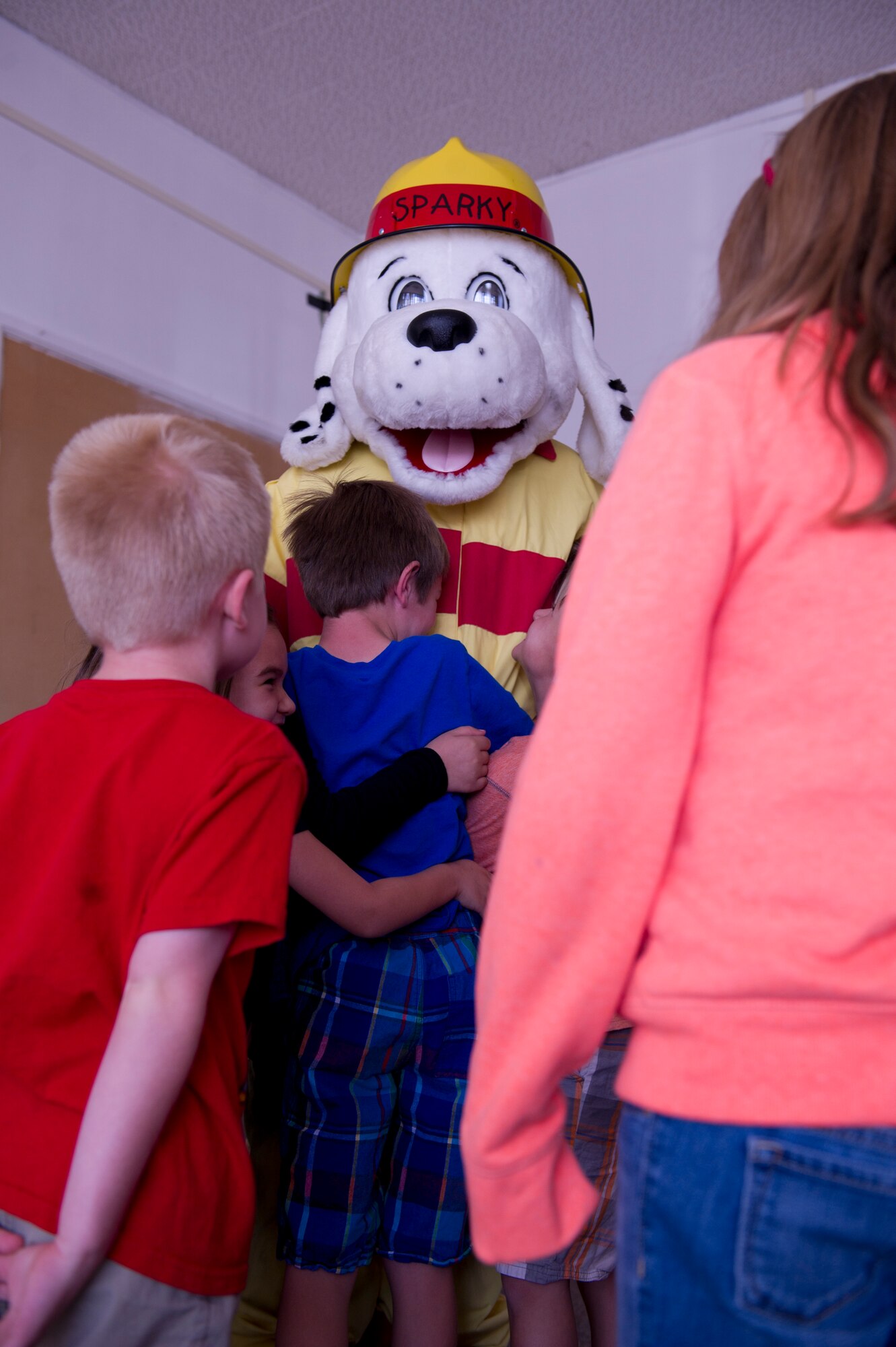 Sparky the Fire Dog greets children from the Holloman Elementary School with a smile and open arms at Holloman Air Force Base, N.M. Oct. 7. Sparky the Fire Dog was created for the National Fire Prevention Association in 1951, and has been the organization’s official mascot ever since. The purpose of Sparky is to visit schools and participate in community events to help spread fire safety messages. (U.S. Air Force photo by Staff Sgt. E’Lysia Wray/Released) 