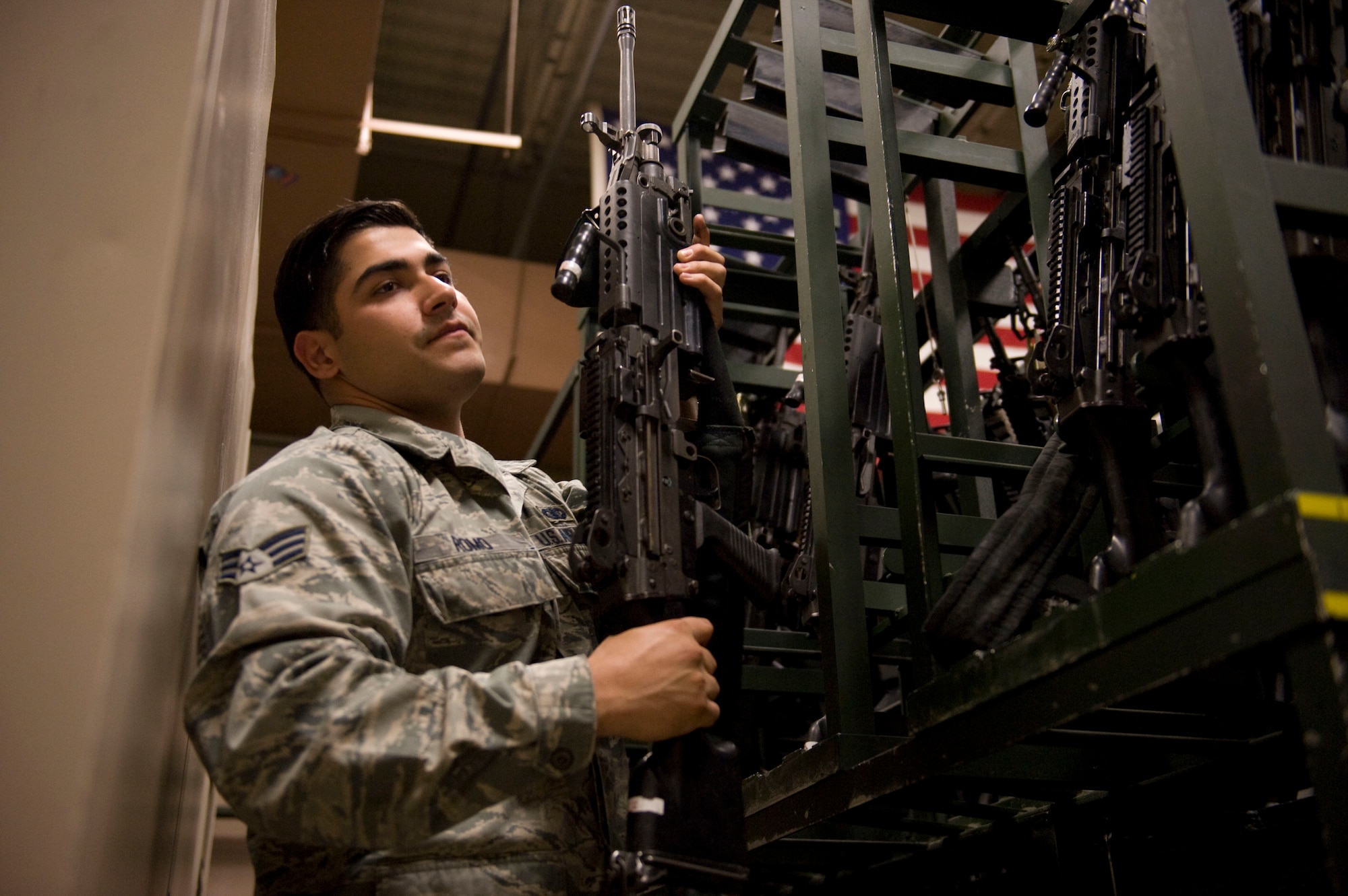 Senior Airman Jaime Romo, 99th Security Forces Squadron armorer, puts a M-240 rifle away after clearing the weapon at the 99th SFS armory at Nellis Air Force Base, Nev., Sept. 12, 2014. Armorers monitor and maintain accountability of all the weapons and munitions in the armory. (U.S. Air Force photo by Airman 1st Class Rachel Loftis)