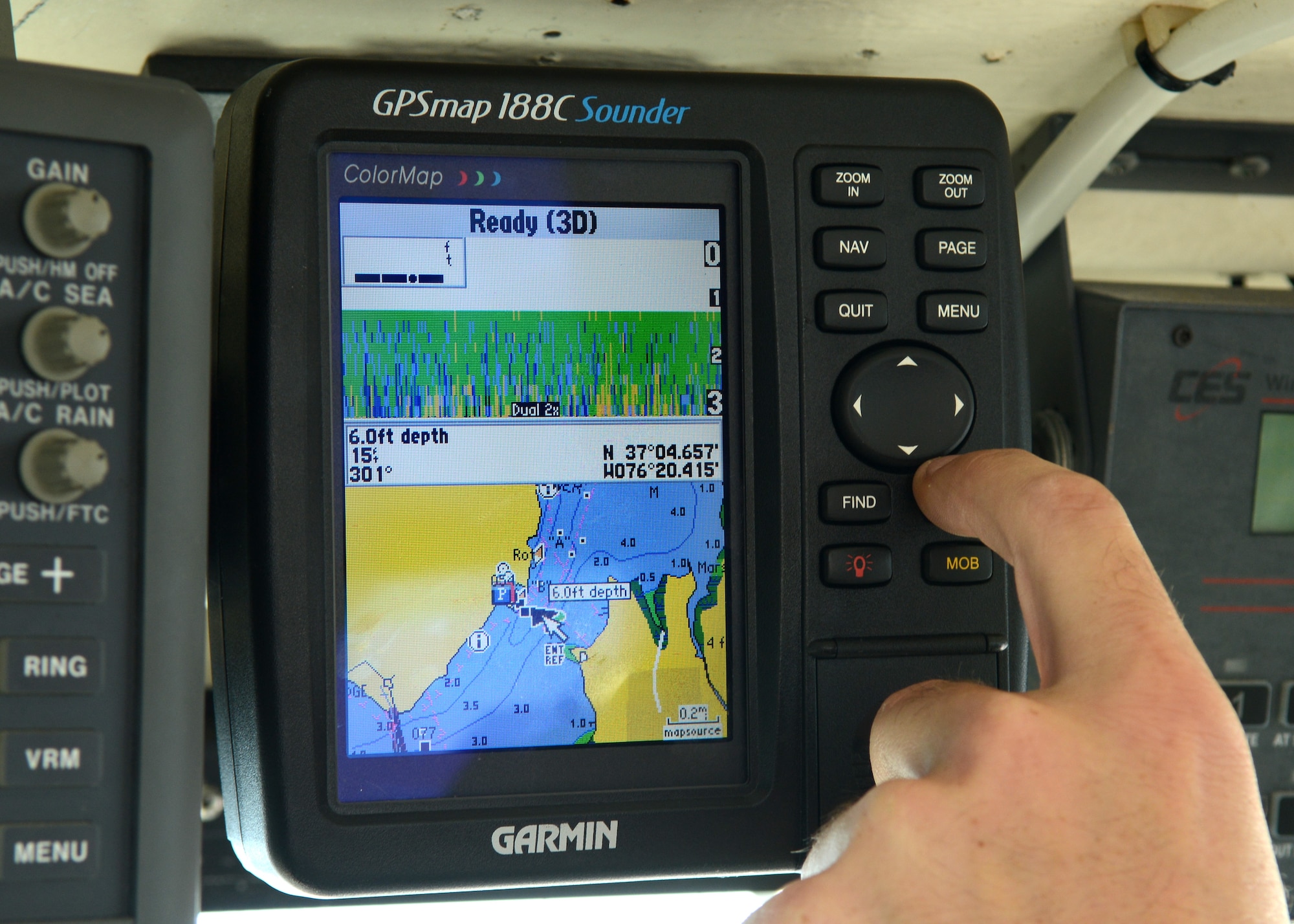 U.S. Air Force Staff Sgt. Robert Sapp, 633rd Civil Engineer Squadron fire rescue crew chief, adjusts a GPS to observe water turbulence below the Langley Fire Rescue boat in Southwest Branch Back River near Langley Air Force Base, Va., Oct. 7, 2014. The boat uses sonar to sense the water’s activity so the operator can gauge driving conditions. (U.S. Air Force photo by Airman 1st Class Devin Scott Michaels/Released)