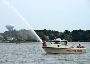 U.S. Air Force Airman 1st Class Scott Kolar, 633rd Civil Engineer Squadron firefighter, shoots water from the Langley Fire Rescue boat during training in Southwest Branch Back River near Langley Air Force Base, Va., Oct. 7, 2014. Several 633rd CES firefighters trained on the pump, which is used in the case of a shoreline fire. (U.S. Air Force photo by Airman 1st Class Devin Scott Michaels/Released)