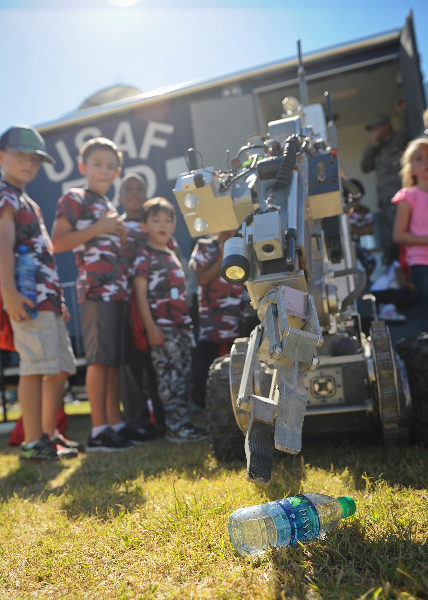 Children are shown the precision of an explosive ordinance disposal robot during the Nellis and Creech Kids Deployment at Nellis Air Force Base, Nev., Oct. 11, 2014. Participants were allowed to guide the robot’s arm and try on the bomb suit used by EOD technicians. (U.S. Air Force photo by Staff Sgt. Victoria Sneed)