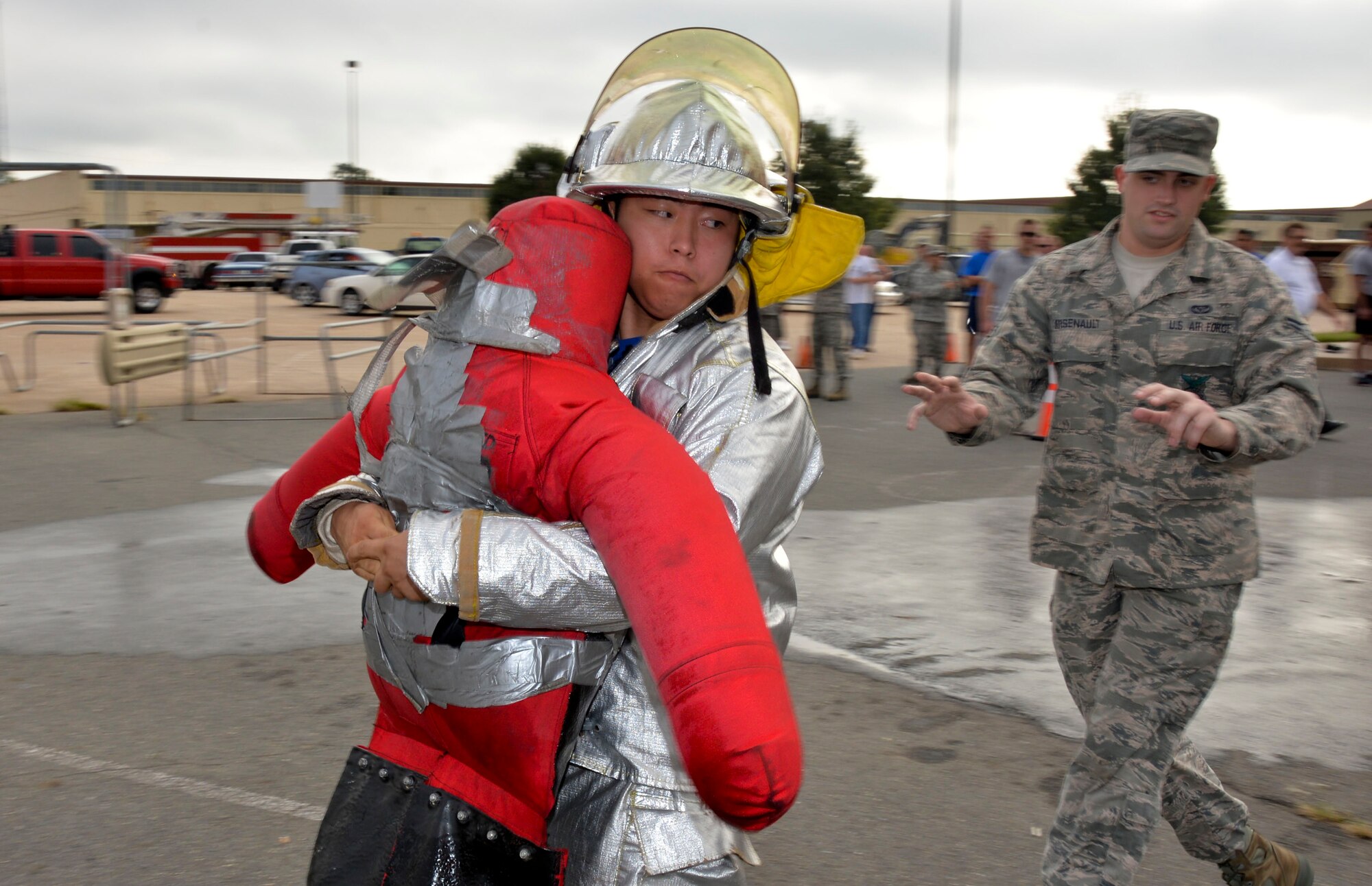 Senior Airman Alex Gaunt, 2nd Civil Engineer Squadron Explosive Ordnance Disposal journeyman, participates in the buddy carry challenge during the 2014 fire muster on Barksdale Air Force Base, La., Oct. 9, 2014. Firefighters use life-size dummies in order to practice moving injured people out of harms way. (U.S. Air Force photo/Airman 1st Class Mozer O. Da Cunha)