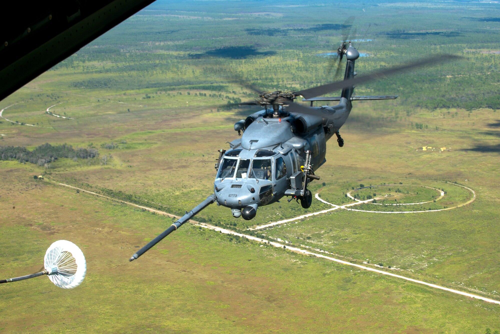 An HH-60G Pave Hawk performs in-flight refueling during a Wing Readiness Inspection Oct. 9. 2014 at Avon Park Air Force, Fla. The WRI system allows wings to perform self-assessments of mission readiness and the HH-60 was used for an extraction of a downed aircrew member during this exercise. (U.S. Air Force photo by Senior Airman Sandra Marrero/Released)
