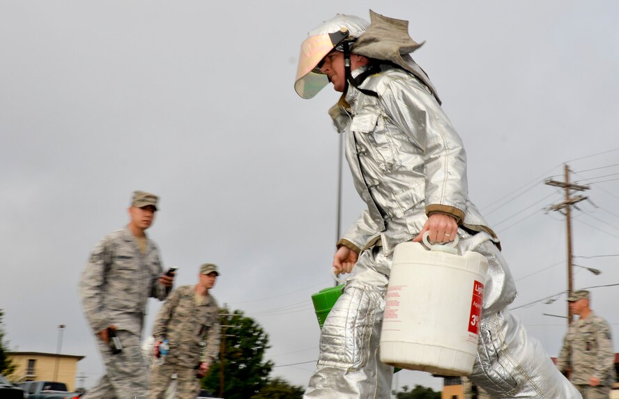 Airman 1st Class Ron Tabago, 2nd Civil Engineer Squadron operations management, participates in the foam bucket challenge during the 2014 fire muster on Barksdale Air Force Base, La., Oct. 9, 2014. The foam bucket competition is used to simulate hand-carrying equipment at a fast pace. (U.S. Air Force photo/Airman 1st Class Mozer O. Da Cunha)