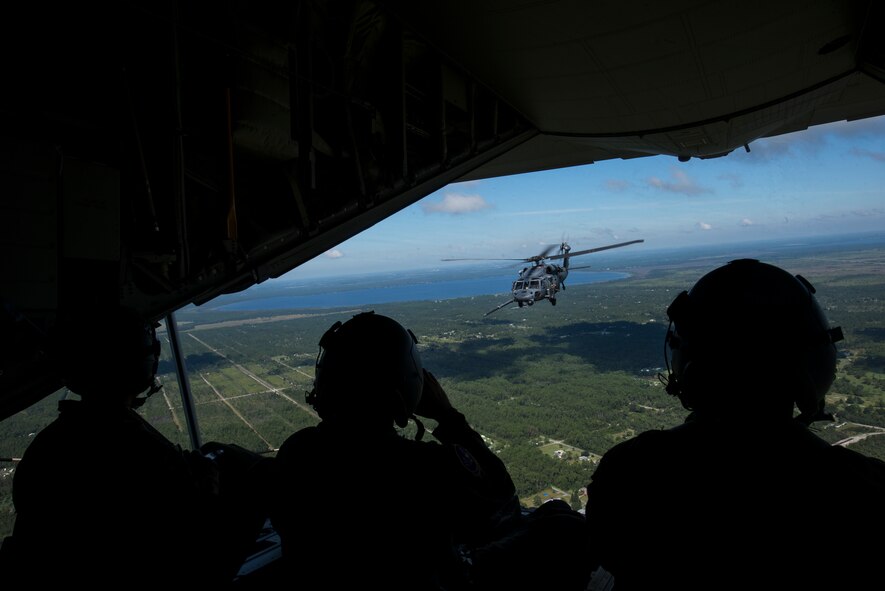 Loadmasters from the 71st Rescue Squadron take in the view during an in-flight refueling of an HH-60G Pave Hawk Oct. 9, 2014 at Avon Park Air Force Range, Fla. The loadmasters worked in support of a combat search and rescue mission during the employment phase of a 23d Wing WRI. (U.S. Air Force photo by Senior Airman Sandra Marrero/Released)
