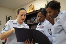 From left, Senior Master Sgt. Shae Alamo, 319th Medical Group superintendent, looks over files with Master Sgt. Lakisha Tucker, 319th Medical Support Squadron superintendent, and Master Sgt. Markiesha Crawford, 319th Medical Operations Squadron superintendent, Oct. 9, 2014, at Grand Forks Air Force Base, N.D. Alamo was awarded the 2014 General Wilma Vaught Visionary Leadership Award Oct. 7, which recognizes individuals who display innovation, commitment, and a selfless spirit of service while being inspiring to others. (U.S. Air Force photo/Airman 1st Class Bonnie Grantham)