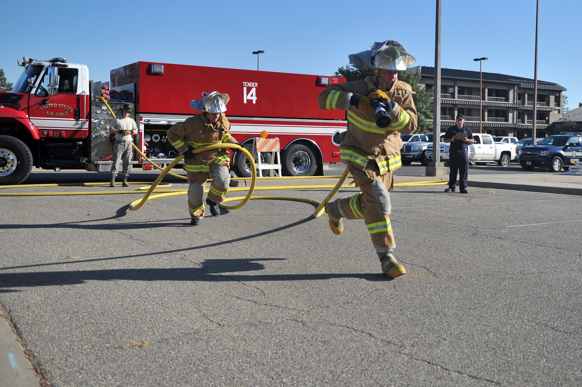 ALTUS AIR FORCE BASE, Okla. – U.S. Air Force Lt. Col. Michael Peeler, 58th Airlift Squadron commander, and U.S. Air Force Senior Master Sgt. Matthew Thrune, 58th AS superintendent, pull a fire hose during this year’s Fire Prevention Week Squadron commander and First Sergeant Challenge Oct. 6, 2014. The challenge consisted of a fire hose drag, dummy carry, fire hose hoist and keiser sled. (U.S. Air Force photo by Senior Airman Dillon Davis/Released)
