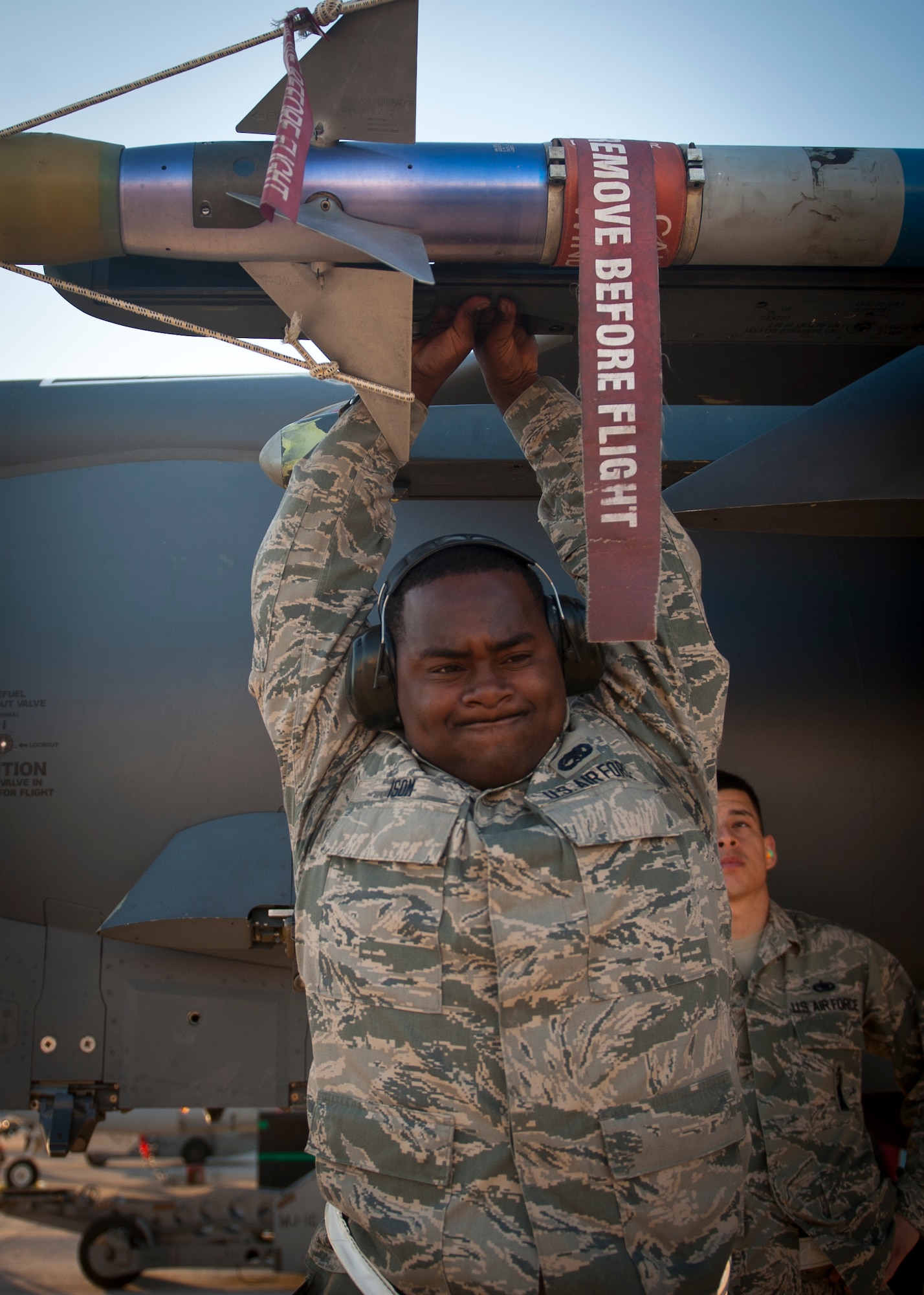 Airman 1st Class Maurice Isom, 757th Aircraft Maintenance Squadron Strike Aircraft Maintenance Unit weapons loader, tightens the connection between an inert missile and an aircraft during a quarterly weapons load crew competition at Nellis Air Force Base, Nev., Oct. 10, 2014. Load crew competitions are held to provide weapons personnel the opportunity to display their war-fighting skills and to unveil the best weapons load crew for a particular quarter during the year. (U.S. Air Force photo by Staff Sgt. Siuta B. Ika)