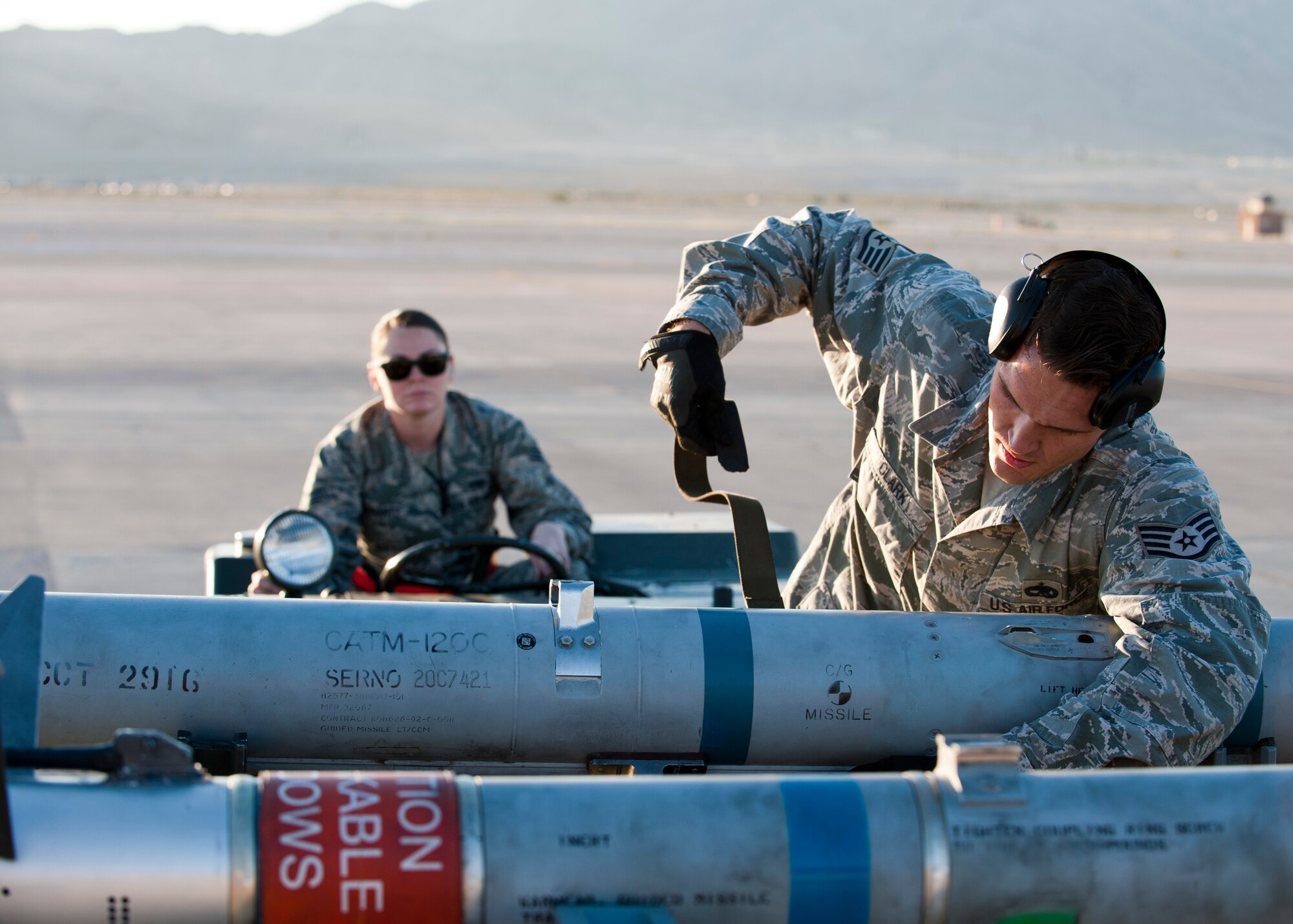 Staff Sgt. Jared Clark, 757th Aircraft Maintenance Squadron Flanker Aircraft Maintenance Unit F-15 Eagle weapons load crew chief, prepares an inert missile for loading during a quarterly weapons load crew competition at Nellis Air Force Base, Nev., Oct. 10, 2014. Load crew competitions are held four times a year, in addition to an annual competition, to see which load crew can correctly load their weapons the fastest. (U.S. Air Force photo by Airman 1st Class Thomas Spangler)