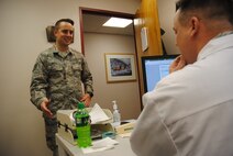 Staff Sgt. Michael Shea, 319th Medical Operation Squadron NCO in-charge of primary care, informs 1st Lt. Ryan Davis, 319th MDOS physician’s assistant, that a patient is ready for his medical consultation Oct. 9, 2014, at the family health clinic on Grand Forks Air Force Base, N.D. In addition to managing a 17-member clinic, Shea works closely with health care providers to ensure patients medical needs are addressed appropriately. (U.S. Air Force photo/Staff Sgt. Luis Loza Gutierrez)