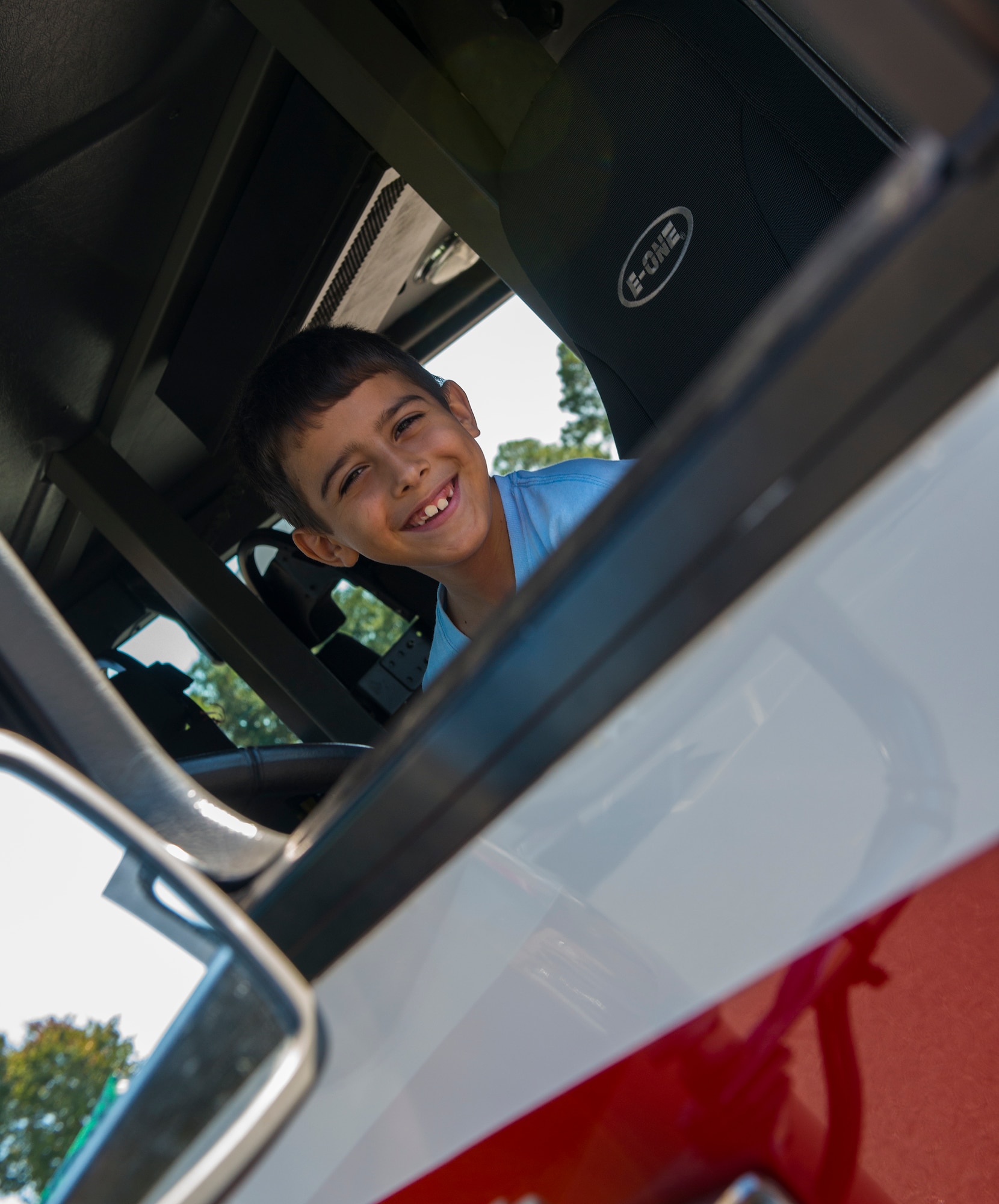 Beto, son of U. S. Air Force Staff Sgt. Jason Cisel, 723d Aircraft Maintenance Squadron, poses for a photo at the Fire Prevention Week Open House Oct. 11, 2014, at Moody Air Force Base, Ga. Firefighters from the 23d Civil Engineer Squadron gave the children a tour of fire trucks. (U.S. Air Force photo by Airman 1st Class Ceaira Tinsley/Released)