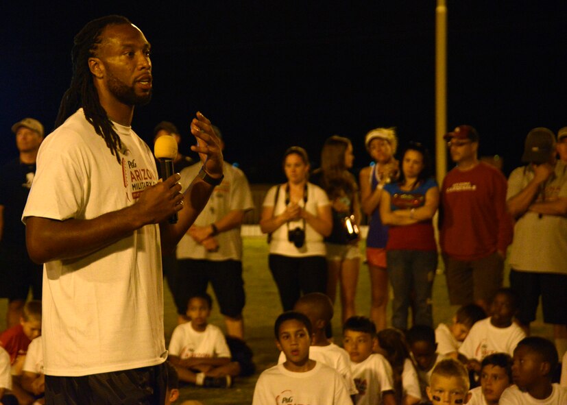 Larry Fitzgerald, Arizona Cardinals wide receiver, speaks with the audience during a Larry Fitzgerald ran two-day football camp at Luke Air Force Base, Arizona, Oct. 13, 2014. Fitzgerald talked to the military children that participated about hard work and his dedication to help children not give up. (U.S. Air Force photo/Senior Airman Devante Williams)